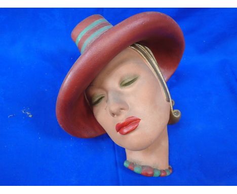 A JOHN DOUGLAS WALL MASK painted plaster representing an Art Deco lady, 33 cms high