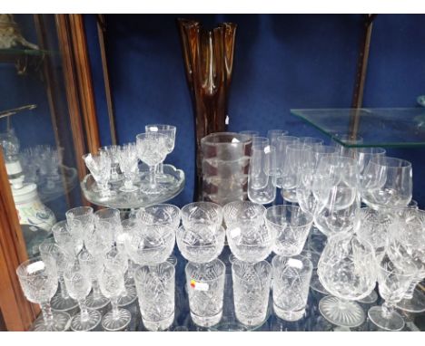 A PART SUITE OF CUT TABLE GLASS, WITH FACETED STEMS including six Champagne coupes, a 1960s art glass vase, and various other