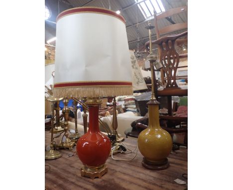 A CHINESE STYLE YELLOW POTTERY LAMP with another similar in terracotta