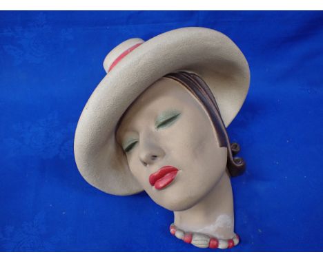 A JOHN DOUGLAS WALL MASK painted plaster representing an Art Deco lady, 33 cms high