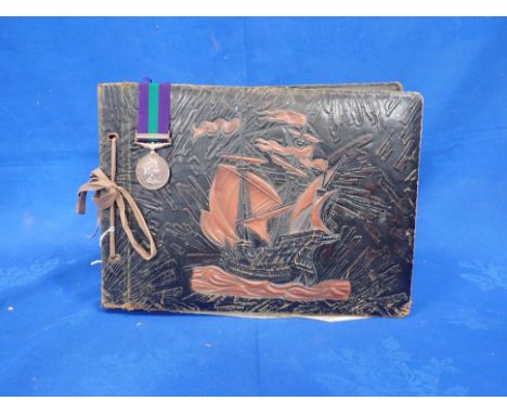 A PHOTOGRAPH/POSTCARD ALBUM OF NATIONAL SERVICE IN CYPRUS 1957, WITH SERVICE MEDAL R. Porter, containing many snapshots of mi