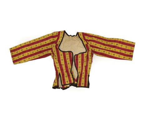 An Early 19th Century Caraco, in a glazed cotton printed with red and yellow stripes printed with a floral sprig, the edges a