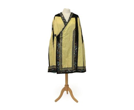 Early 20th Century Chinese Yellow Silk Brocade Cape with black silk shoulders, applied, embroidered and woven black silk trim