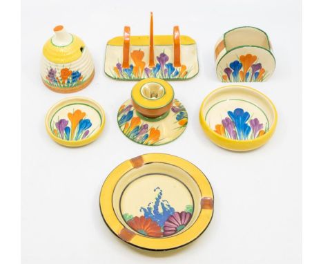 A collection of Clarice Cliff Crocus pattern items including pin dishes, candlestick, sugar, toast rack and a preserve pot, p