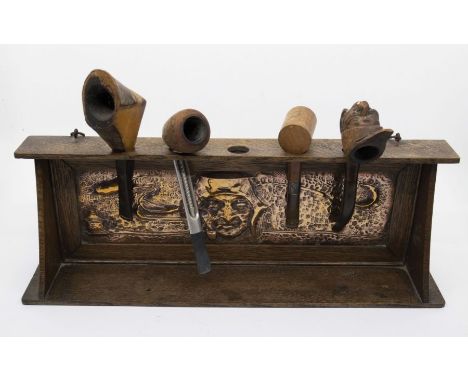 Arts &amp; Crafts pipe rack with embossed copper panel depicting smoking man plus four pipes. Length approx 39cm, height appr