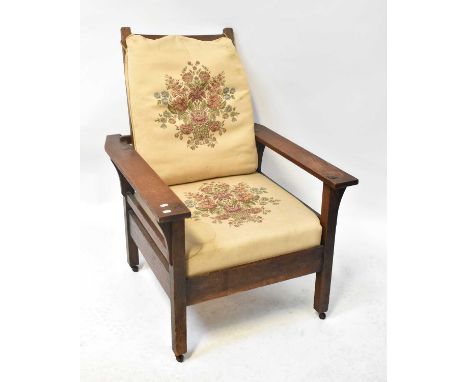 A 1930s oak adjustable open arm elbow chair with ladder back and loose tapestry-style cushions, height 108.5cm.Condition Repo