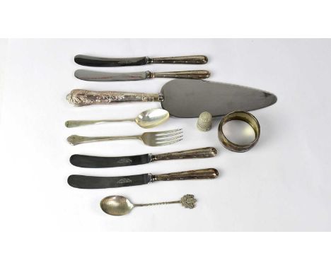 A small mixed lot of silver, comprising a thimble, napkin ring, two teaspoons, fork, a set of four silver-handled butter kniv