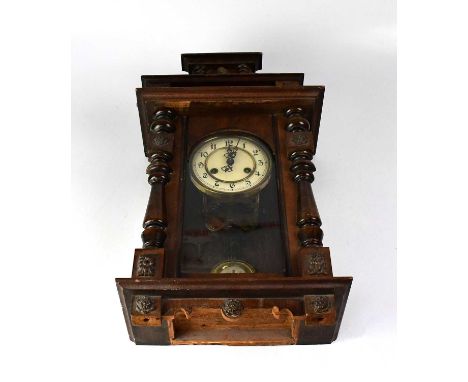 A mahogany cased spring-driven Vienna wall clock, the ivorine dial set with Arabic numerals, the case with columns and applie