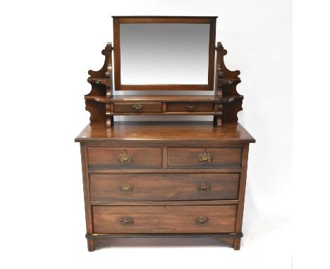 A stained oak dressing chest with bevelled mirror plate above a pair of jewellery drawers and open shelf, above a base of two