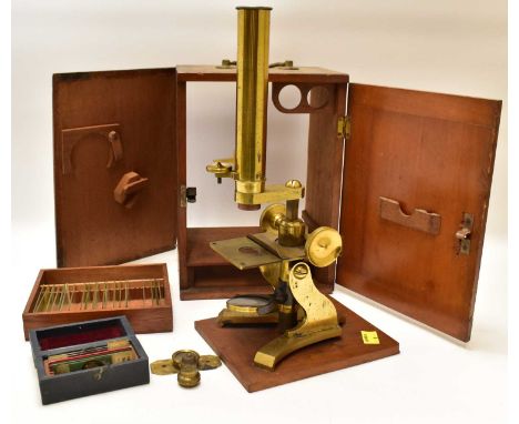 J. H. STEWARD, 456 WEST STRAND, LONDON; a vintage brass microscope with ratchet adjustment, in wooden case, with small drawer