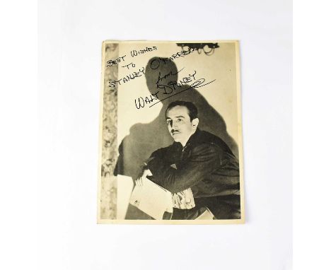 WALT DISNEY; a black and white promotional photograph inscribed 'Best wishes to Stanley O'Farrell' and bearing signature, in 