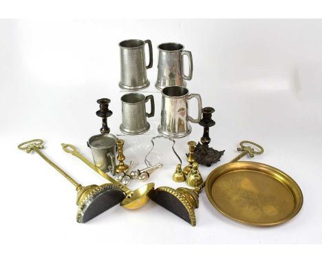 A small quantity of metalware to include five pewter tankards, two weighted brass doorstops, a small charger decorated with a