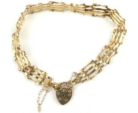 A 9ct gold four bar gate bracelet united with a 9ct heart-shaped padlock clasp, length approx. 17cm, approx. 4g.