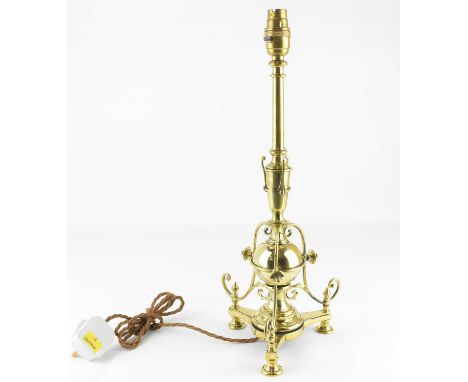 An early 20th century Arts and Crafts cast brass candlestick, height 43cm.Condition Report: Bulb holder possibly added later 