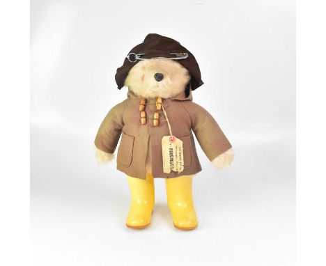 A Paddington Bear plush teddy wearing duffel coat and yellow wellingtons, height 50cm.