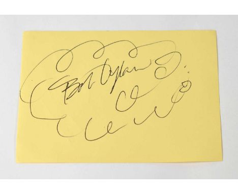 BOB DYLAN; a torn page from an autograph book signed by the singer.Condition Report: - We have not authenticated this signatu