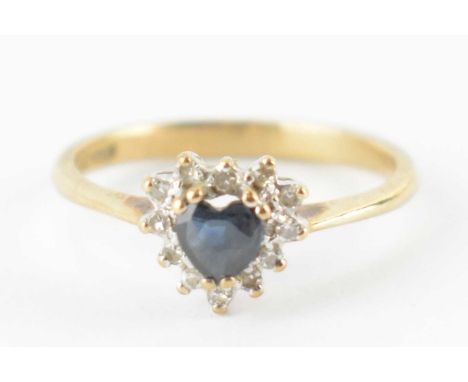 A 9ct gold ring with central heart-shaped sapphire in a heart-shaped border cluster of tiny diamonds, size K, approx. 1.6g.