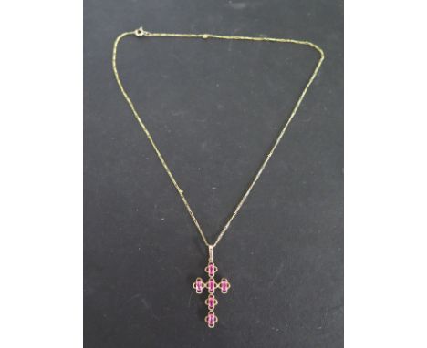 A 9ct gold pink stone set cross on chain - weight approx 3.8 grams - good condition