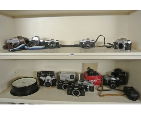 A collection of ten 35mm SLR cameras and bodies, a Smiths darkroom timer, Sigma telephoto and two flashes