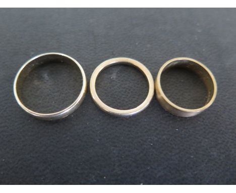 Three 9ct yellow gold wedding bands sizes K, K & R - approx weight 6.5 grams - all have some usage wear