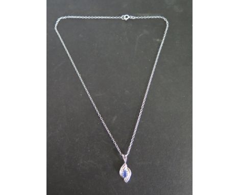 A 9ct white gold blue topaz pendant on chain - weight approx 3.5 grams - good condition