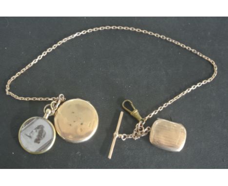 A 15ct yellow gold circular locket on a 9ct yellow gold watch chain with T-bar - total weight approx 27.5 grams - in good cle