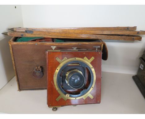 A wooden and brass tripod camera, late 1800's, mahogany in very good condition as is the lacquered brass complete with holdal
