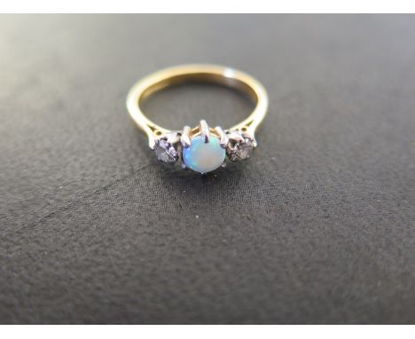 An opal and diamond 18ct yellow gold ring size M - approx weight 3 grams - opal fiery, diamonds bright