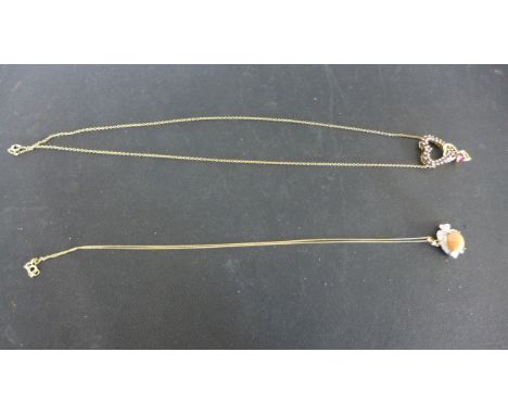 A 9ct yellow gold and amethyst heart shaped pendant on chain and a 9ct yellow gold fish shaped pendant on chain