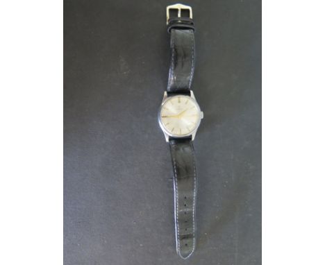 A circa 1943 gents Omega bubble back wristwatch in stainless steel case with baton markers, centre sweep second - in working 
