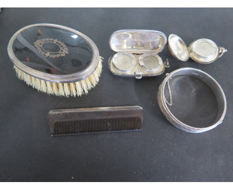 A silver hallmarked Sovereign holder - The white metal Sovereign holder with a silver hallmarked bracelet, a silver and torto