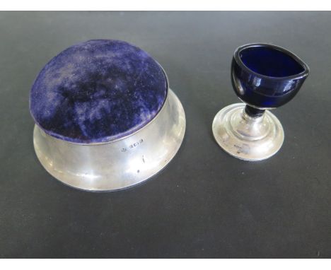 An oversized silver pin cushion trinket box - Diameter 12cm - Birmingham 1910/11 - and an eye bath on silver stand