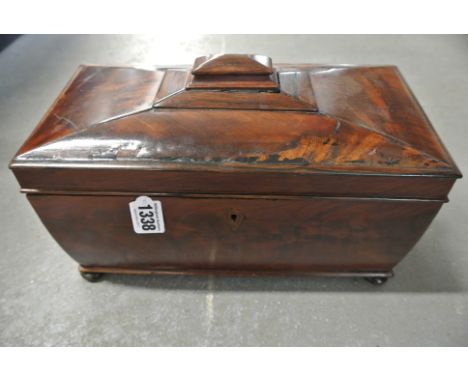 A 19th century flamed mahogany tea caddy of sarcophagus form
