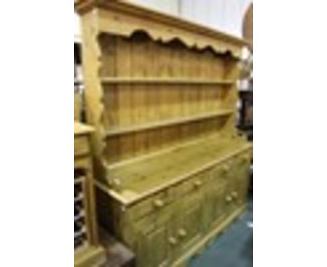 Victorian style pine dresser, the plate rack with an undulating rail above two shelves, the base with four frieze drawers abo