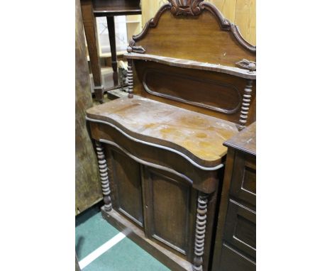 Victorian mahogany chiffonier, the shelved gallery back above a cushion drawer, raised on two paneled doors, opening to revea