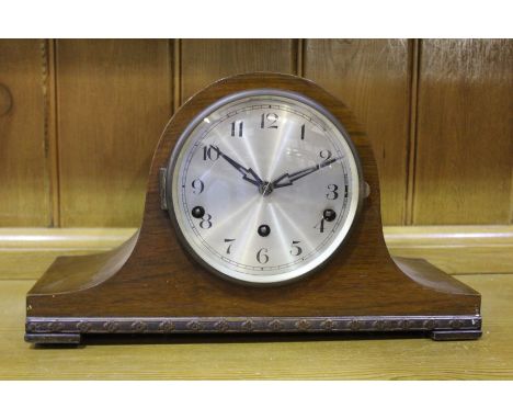 Edwardian walnut mantel clock, the arched case and silvered dial with Arabic numerals, 38cm wide