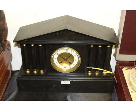 Edwardian slate mantel clock, of architectural form, with triangular pediment, the white dial with Arabic numerals, flanked b