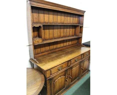 18th Century style oak dresser, the plate rack with two shelves flanked by two small drawers, the dresser base with three fri