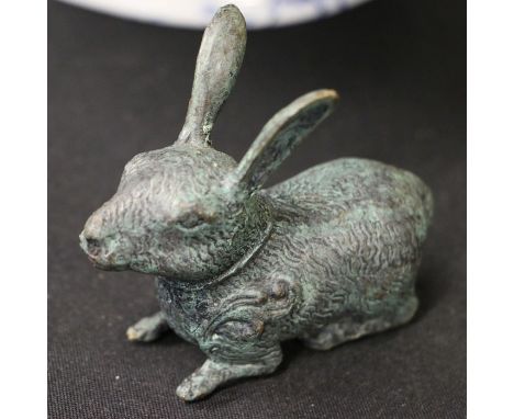 Bronze effect brass rabbit, depicted in a laying position with ears raised, 9cm long