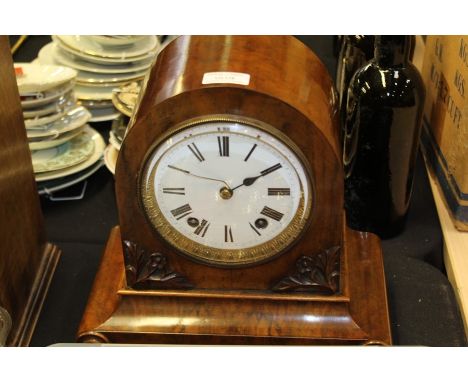 Winterhalder and Hofmeier walnut cased mantel clock, the arched case with roundel decorated plinth base, the dial with Roman 