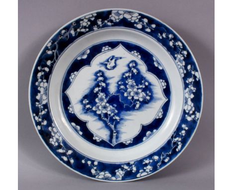 A FINE QUALITY CHINESE KANGXI PERIOD BLUE AND WHITE BIRD AND PRUNUS DISH, the base with Artemisia mark, 27cm diameter.