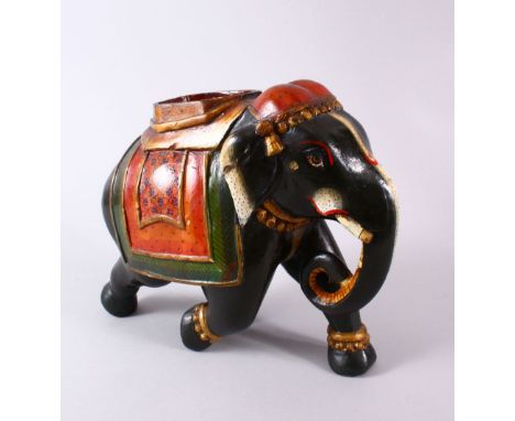 AN INDIAN LACQUER MODEL ELEPHANT, with decorated wears, 30cm wide