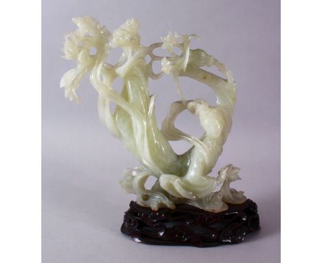 A CHINESE CARVED JADE FIGURE OF A GODDESS / GUANYIN, in an unusual curvature pose with native flora and upon stylized waves w