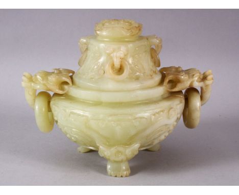 A CHINESE CARVED JADE TRIPD LIDDED CENSER, carved with lion dog handles and rings, stood upon three carved claw feet, the cov