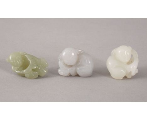 THREE 19TH / 20TH CENTURY CHINESE CARVED WHITE / CELADON JADE FIGURES - BOYS, the carving depicting a boy recumbent holding a