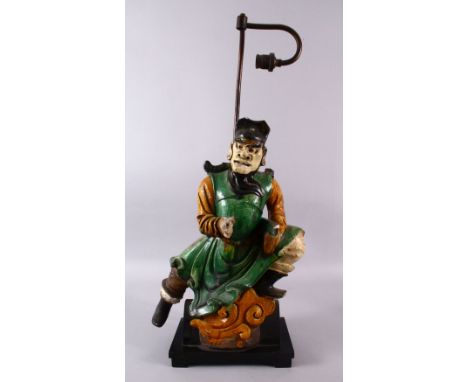 A CHINESE SANCAI GLAZED FIGURE OF A WARRIOR AS A LAMP, the figure fitted to a wooden base with light fittings, the figure alo