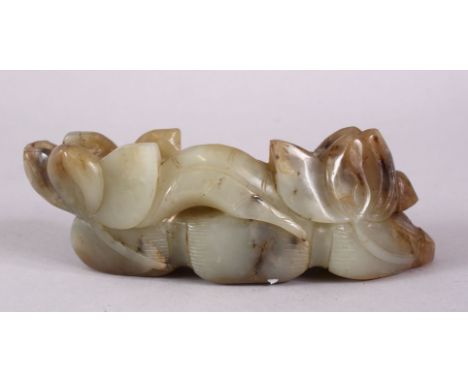 A CARVED CHINESE JADE LOTUS FORM STAND, carved with lotus emerging from the ground, 15cm.