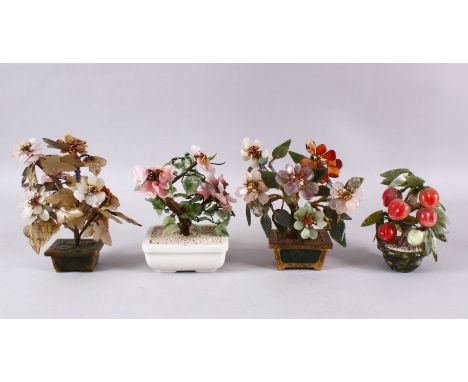 A MIXED LOT OF FOUR CHINESE CARVED JADE BONSAI / TREES, One of a peach tree, the other with native floral decoration, two jad