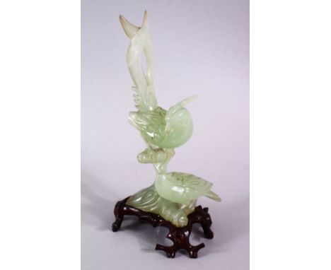 A CHINESE CARVED GREEN JADE FIGURE OF TWO BIRDS, both seated upopn a naturalistic formed branch, with a carved wooden fitted 