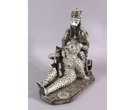 A RARE &amp; UNUSUAL SIGNED 19TH CENTURY PERSIAN QAJAR GLAZED POTTERY FIGURE OF RUSTAN SLAYING THE WHITE DEVIL, 30cm high X 2